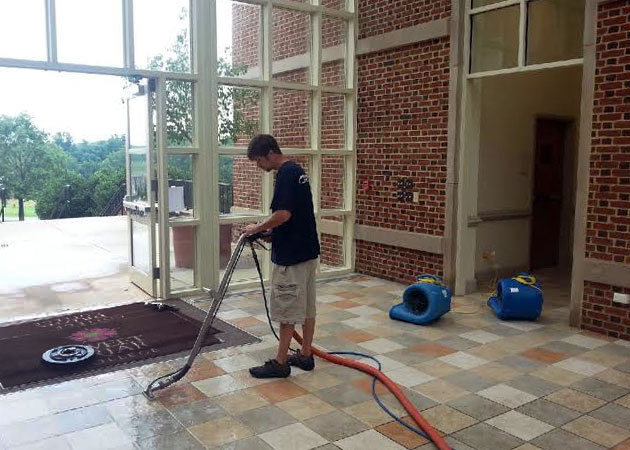 A man cleaning a tile floor